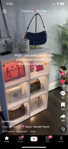 a display case with purses and bags on it