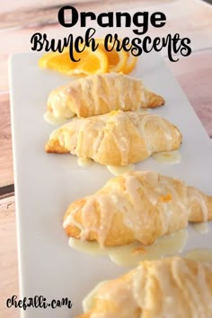 orange brunch crescents are lined up on a white plate