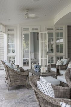 an outdoor living area with wicker furniture