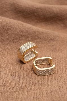 Elevate your look with these stunning Barbie Brides Huggie Earrings. The earrings feature exquisite micro pave cubic zirconia in a round shape set in 18K gold-plated copper. The clip-on closure makes them easy to wear and suitable for any occasion, be it an engagement, wedding, graduation, birthday, Christmas or Valentine's Day gift. The beauty of these earrings lies in their excellent cut grade and silver-colored main stone color, which reflects light beautifully. The huggie hoop style with a pavé setting adds a touch of glamour and sophistication. These earrings are also nickel-free, making them safe for those with sensitive ears. Add a touch of beauty to any outfit with these gorgeous earrings. Gold Huggie Diamond Earrings With Pave Setting, Luxury Gold Hoop Earrings With Pave Setting, Luxury Gold Cubic Zirconia Huggie Earrings, Barbie Bride, Women Earrings, Pave Setting, Huggie Earrings, Micro Pave, Sensitive Ears