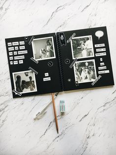 an open book with pictures on it next to some pens and pencils sitting on a marble surface