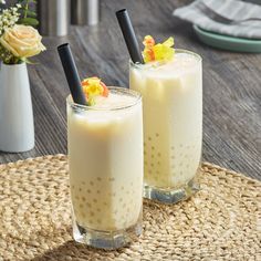 two glasses filled with liquid sitting on top of a table