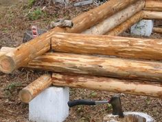 a pile of logs sitting on top of a forest floor next to a fire hydrant