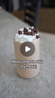 mocha coffee smoothie with whipped cream and chocolate chips in a glass on a table