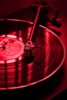 a turntable with a red light shining on it