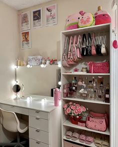 a white desk topped with lots of drawers and pink purses on top of it