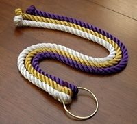 a purple, yellow and white rope on a table