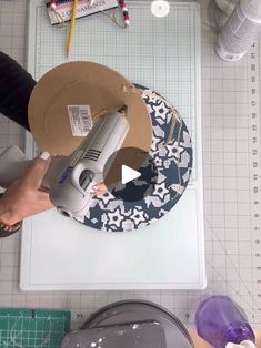 a person using a machine to cut paper