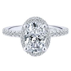 an oval cut diamond engagement ring with halos