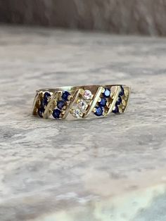 Vintage Sapphire CZ ring Fine jewelry Size 6 Gold plated, pure silver ring Mid century style 12 Simulated sapphire stones each measuring 1 mm round Three CZ stones each measuring 1 mm round Pretty and Dainty 1970 to 1980s ring Handset by experience jeweler Fast and free shipping  Star seller shop Fine Jewelry Multi-stone Sapphire Promise Ring, Multi-stone Sapphire Promise Ring, Sapphire Cubic Zirconia Cluster Ring For Promise, Sapphire-colored Diamond Ring With Accent Stones For Anniversary, Diamond White Multi-stone Sapphire Ring, Blue Diamond Ring With Accent Stones For Anniversary, Sapphire Rings With Diamond Accents For Promise, Anniversary Sapphire Diamond Ring With Multi-stones, Sapphire Multi-stone Diamond Ring Gift