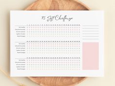 a wooden plate with a pink and white checklist on it