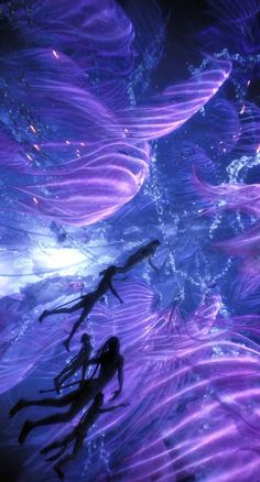 two people swimming in the water with purple swirls