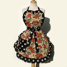 a dress that has skulls and roses on it, with black polka dots around the collar