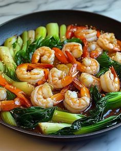 shrimp and vegetable stir fry in a wok on a marble countertop, ready to be eaten