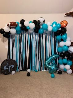 a balloon arch with football balloons and streamers