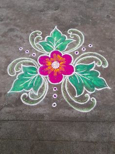 a flower painted on the ground with green leaves and dots around it in white chalk