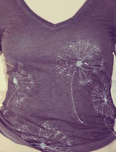 a women's t - shirt with dandelions on it