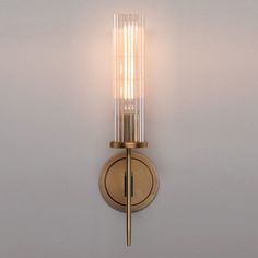 a light that is on the side of a wall with a glass tube attached to it