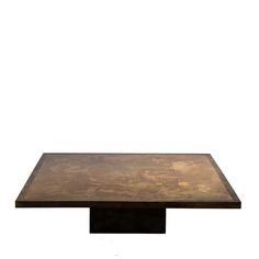 a square wooden table sitting on top of a white floor next to a black metal base