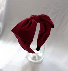 Add a touch of elegance to your formal events and cocktails with this classic big wine red bow headband. Handcrafted with care, this headband is the perfect accessory to elevate any outfit. The deep wine red color adds a stylish pop to your look, while the oversized bow design exudes timeless charm. Whether you're attending a wedding, cocktail party, or special event, this headband will surely make a statement. Stand out in style with this sophisticated and chic accessory. Bow size Approximately Satin Bow Headband For Party, Formal Adjustable Bow Headband, Formal Adjustable Headband With Bow, Elegant Adjustable Bow Headband, Adjustable Elegant Bow Headband, Elegant Red Adjustable Bow, Formal Bow Headband, Elegant Ribbon Bow Headband, Elegant Party Headband With Decorative Bow