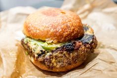 a hamburger sitting on top of a piece of wax paper