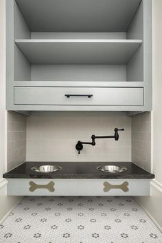 two stainless steel sinks in the middle of a cabinet