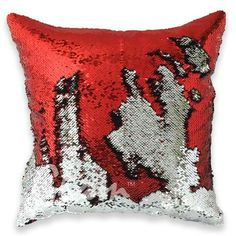 a red and silver sequinized pillow with an image of a horse on it