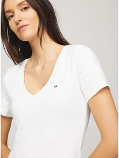 Tommy Hilfiger women's T-shirt. Made from soft, medium weight cotton, our Favorite Tees are designed to fit your form. Another reason to love them? They layer just as easily under a blazer as they do a zip hoodie.  Material: 100% Regenerative Cotton. Trendy Tommy Hilfiger Cotton T-shirt, Essential Cotton Tops For Spring, Essential Cotton Spring Tops, Essential Short Sleeve Summer Tops, Classic Tommy Hilfiger T-shirt For Summer, Classic Tommy Hilfiger Summer T-shirt, Trendy Tommy Hilfiger Cotton Tops, Fitted Tommy Hilfiger Tops For Summer, Tommy Hilfiger Fitted Summer Tops