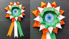 two different types of origami flowers with ribbons attached to each flower, one in green and the other in orange