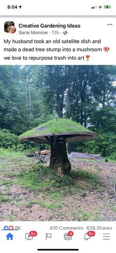 an image of a mushroom like structure in the middle of a field with trees behind it