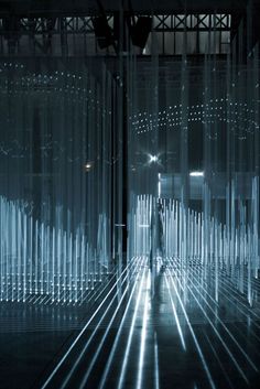 a person standing in front of an array of lights