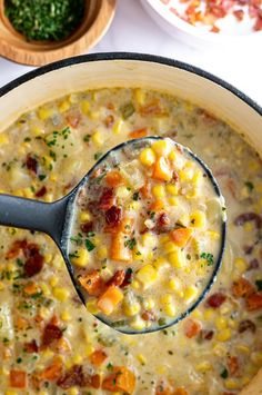 a large pot filled with corn and bacon soup