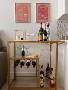 Good bar cart inspired for a small area. Cute color wall art. Fun glasses from cb2. Wine bottles. Wine glasses. Cheap Bar Cart Ideas, Simple Bar Cart Ideas, Bar Ideas Apartment, Cute Bar Set Up, Bar Cart With Fridge, Target Mini Bar Cart Ideas, Bar Cart Inspo College, College Bar Cart Ideas, Cheap Bar Cart