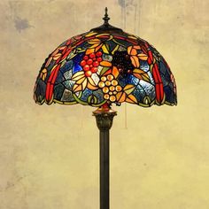 a stained glass lamp on a metal stand