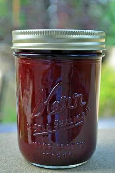 a jar filled with red liquid sitting on top of a table