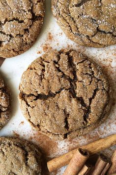 several cookies and cinnamon sticks on a table