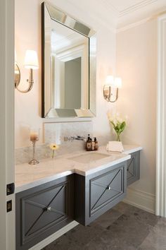 a bathroom with two sinks and a large mirror