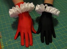 there are two gloves that have ruffles on the wrist and one is red