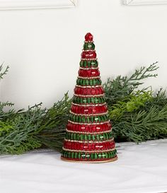 a red and green christmas tree sitting on top of a table