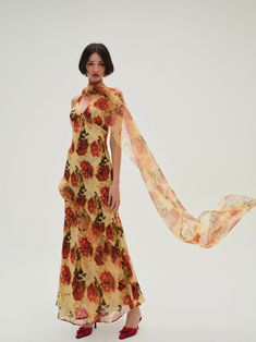 Inspired by vintage gowns, the Floral Stems yellow maxi dress spotlights an exquisite abstract rose print on delicate chiffon and organza. Cut to a plunging neckline, and featuring a low, open backthis long floral dress is decorated with cascading ruffles and a built-in shawl that you can throw over your shoulders for an elegant finish. Consider it the perfect wedding guest dress for the season's upcoming weddings. Shawl Over Dress Wedding Guest, Dress With Shawl Wedding Guest, Floral Dress Long Sleeve, Beach Bach, Perfect Wedding Guest Dress, Long Floral Dress, Abstract Rose, Yellow Maxi Dress, Yellow Maxi