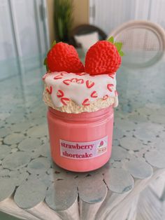 there is a strawberry shortcake in a jar on the table