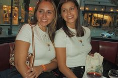 two women sitting next to each other at a table