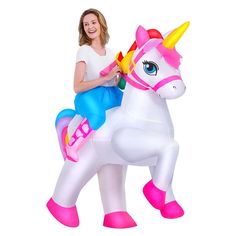 a woman sitting on top of a inflatable unicorn