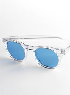 Semi-round Sunglasses in Clear with Blue Lenses - The Ben Silver Collection Sunglasses Blue Lenses, Modern Round Clear Sunglasses, White Round Sunglasses With Tinted Lenses, Modern Round Glass Sunglasses, Clear Sunglasses With Tinted Round Frame, Round Sunglasses With Mirrored Lenses And Glass, Clear Sunglasses With Tinted Lenses And Round Frame, Clear Round Frame Polarized Sunglasses, Clear Round Frame Sunglasses With Tinted Lenses