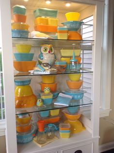 a shelf filled with lots of colorful dishes