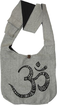 A simple, yet graceful grey colored shoulder bag in a textured cotton fabric with black textile weave details and a big Om print.  The bag closes on the top with a zipper and a button, and there's a small pocket inside the bag that closes with a velcro. #tlb #Pocket #Yoga #vacationclothing #Printed #bohemianfashion #Indian #HinduReligiousBag #PanditjiBag Casual Gray Cotton Bag, Gray Cotton Canvas Bag For Travel, Gray Canvas Shoulder Bag, Gray Cotton Canvas Travel Bag, Rectangular Gray Cotton Shoulder Bag, Gray Cotton Canvas Bag For Daily Use, Gray Cotton Tote Bag, Gray Canvas Rectangular Shoulder Bag, Gray Cotton Shoulder Bag