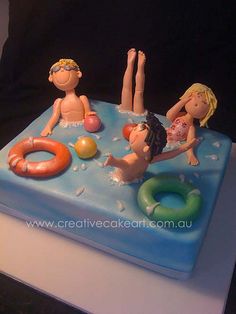 there is a cake that looks like people in the water on top of an inflatable raft