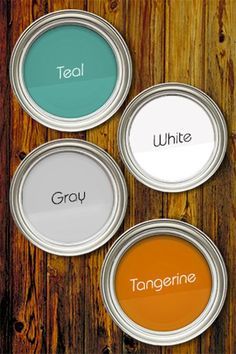 four paint cans with the words white, gray and tangerine painted on them in different colors