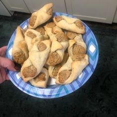 a blue and white plate topped with meat filled pastries