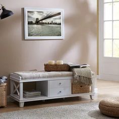 a white bench sitting on top of a wooden floor next to a rug and window